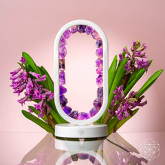 Decorative lamp with purple flowers on a pink background