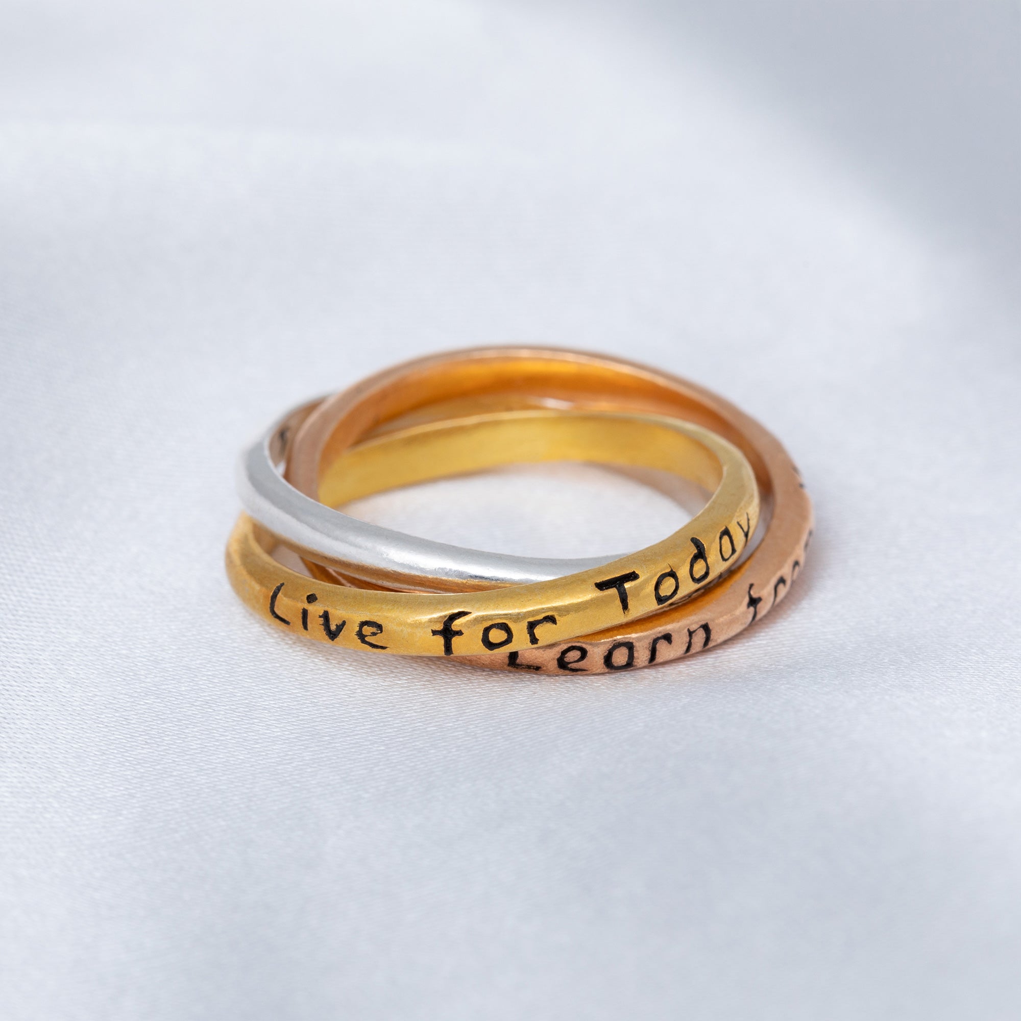 Three rings stacked on a light gray background with 'Live for Today, Learn Now' text.