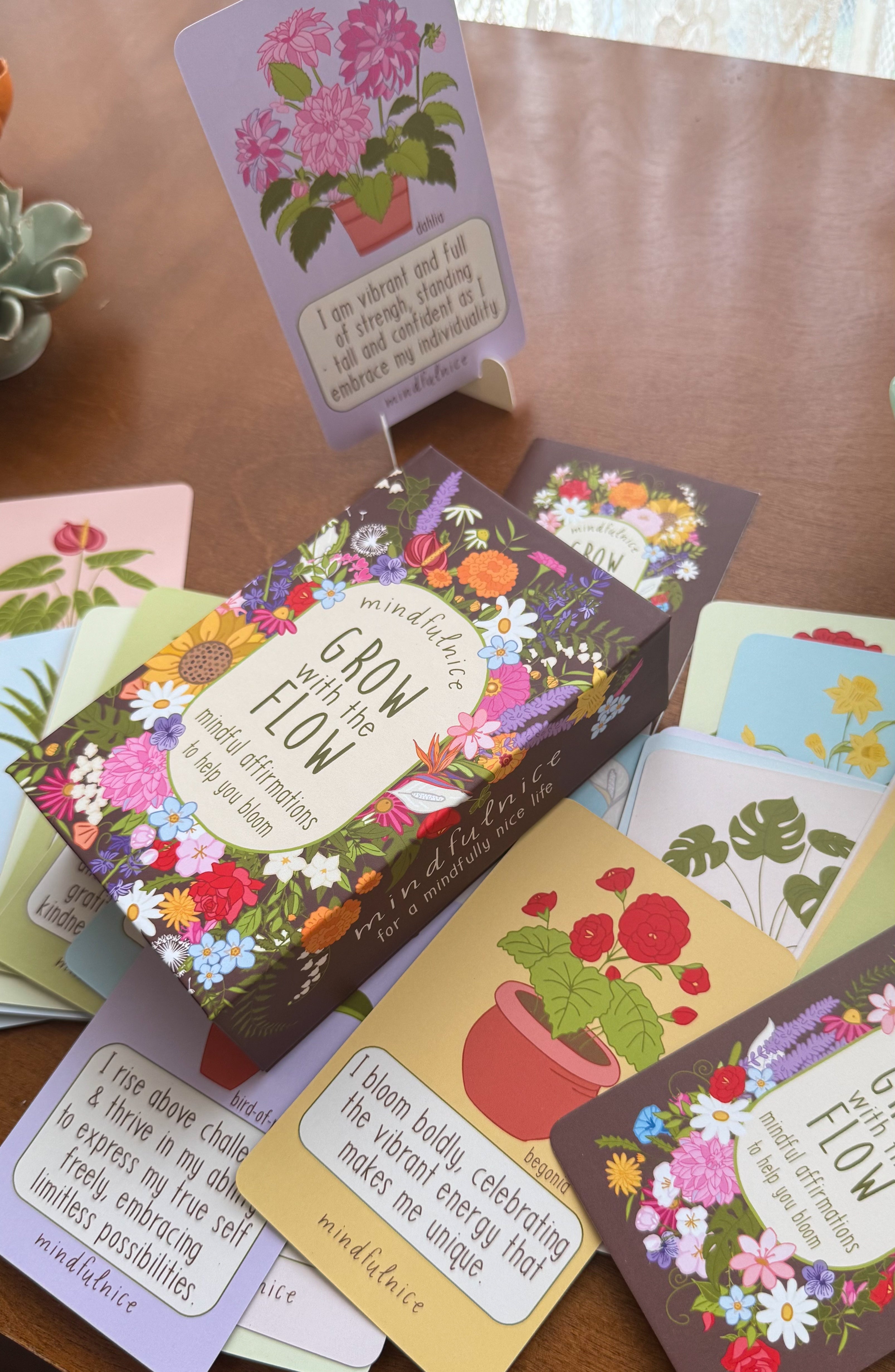 Collection of floral-themed cards on a wooden surface